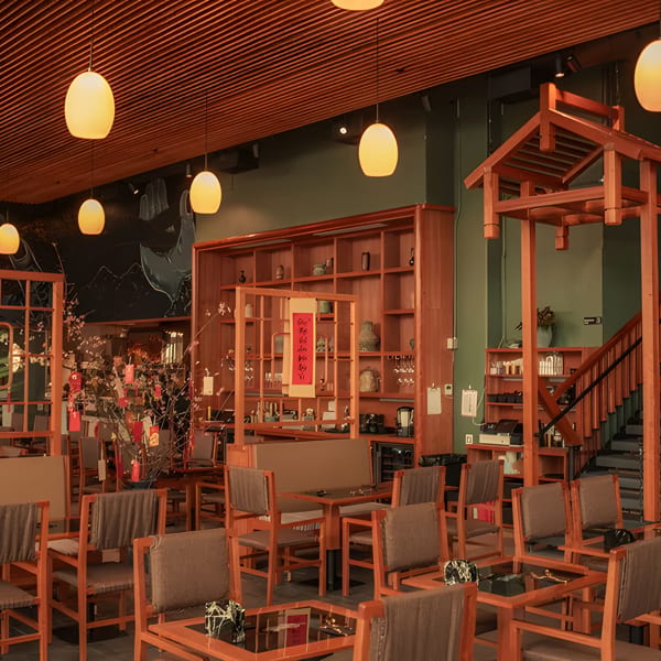 A restaurant interior with wooden furniture, warm lighting, and traditional Asian decor.